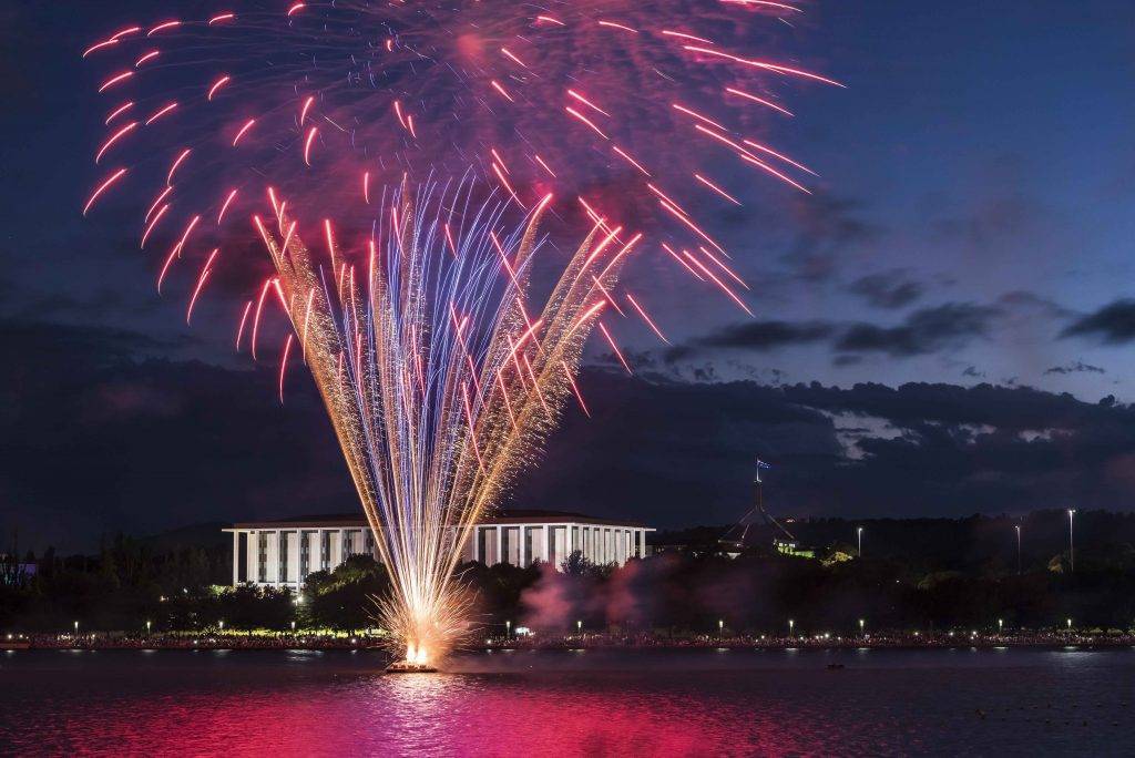 "Spectacular fireworks display over Lake Griffin in Canberra during New Year's Eve or Australia Day celebrations."