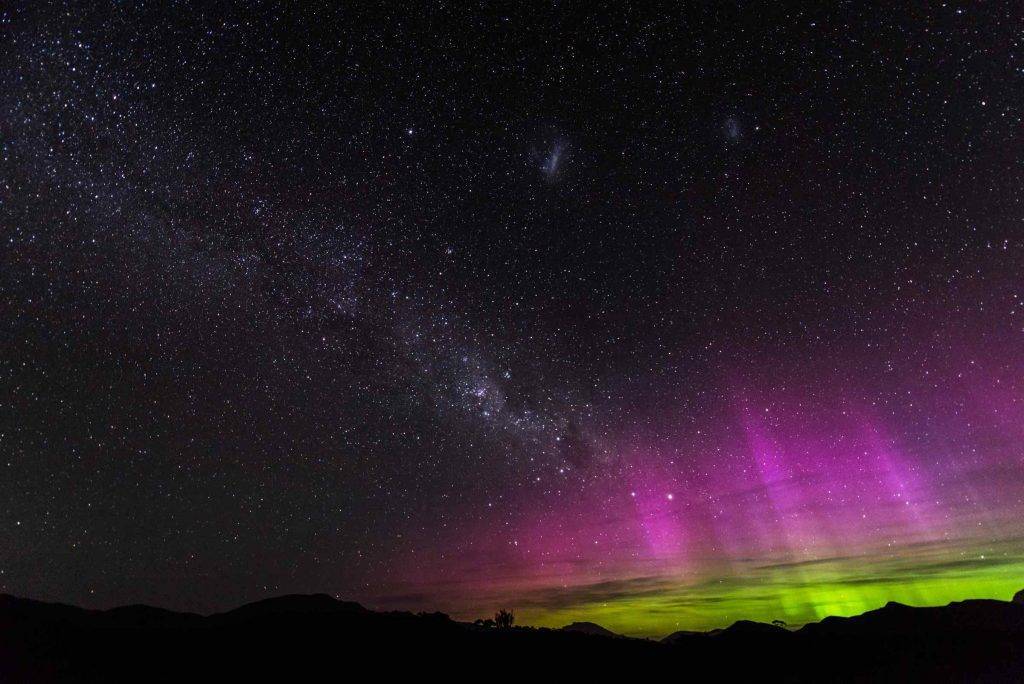 "Spectacular view of Aurora Australis illuminating Tasmania's night sky."