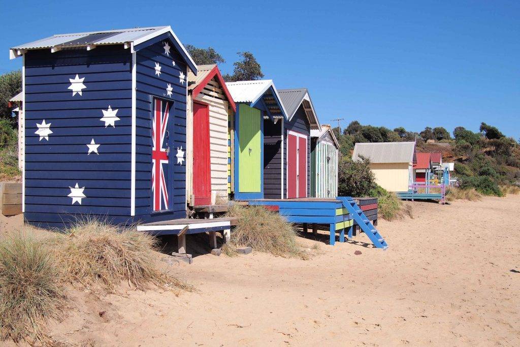 "Colorful bathing boxes lining the shores of Mornington, a symbol of the area's coastal beauty."