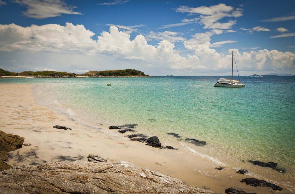 "Sailing around the picturesque Great Keppel Island, highlighting its crystal-clear waters and scenic beauty."